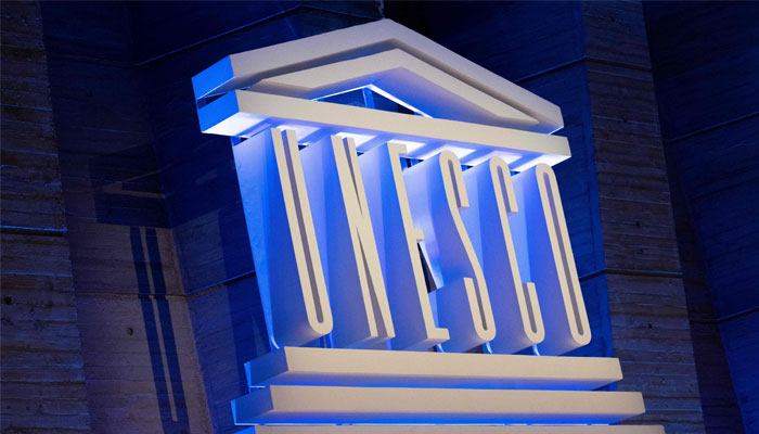 A photo shows the UNESCO logo during a speech by its director-general. — AFP