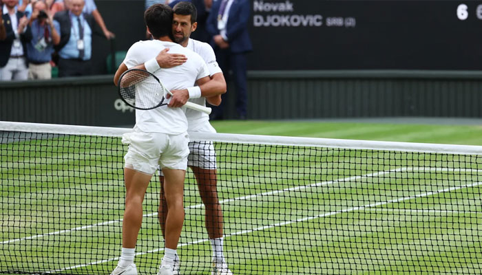 Carlos Alcaraz and Novak Djokovic embrace after the Wimbledon final.—Reuters