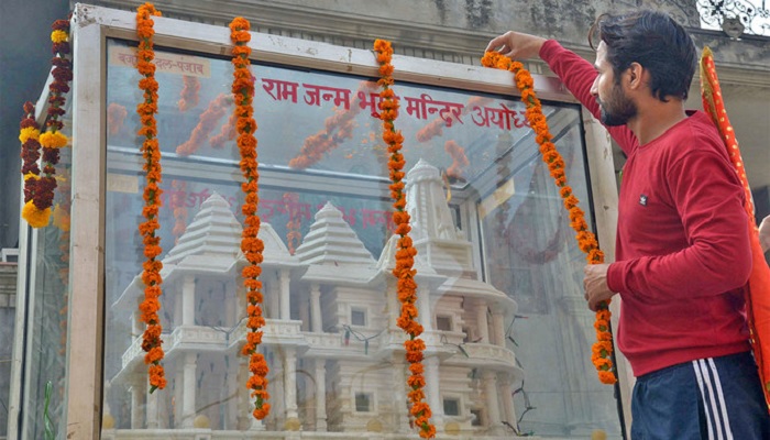 A member of Hindu Bajrang Dal garlands a model of a Ram temple during a procession marking the 24th anniversary of the demolition of the Babri Masjid Mosque in Ayodhya, in Amritsar on December 6, 2016.— AFP/File