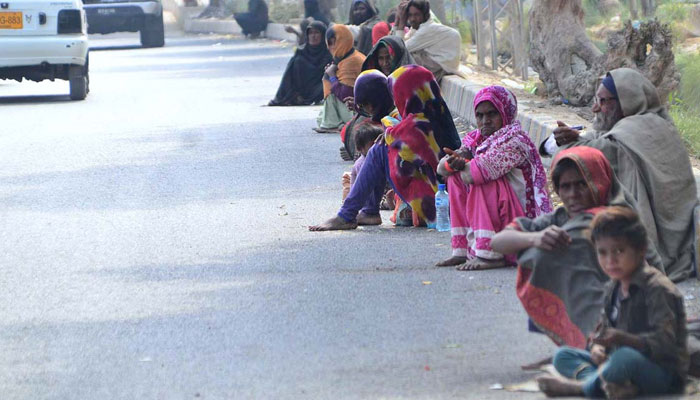 A large number of beggars sitting on the roadside waiting for mercy at Wahduwah road on February 10, 2022 — APP.