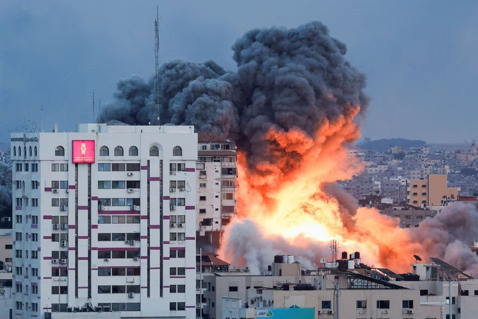 Smoke and flames billow after Israeli forces struck a high-rise tower in Gaza City, on October 7, 2023. — Reuters