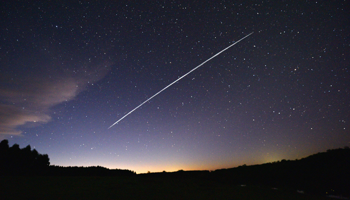 This long-exposure image shows a trail of a group of SpaceXs Starlink satellites passing over Uruguay as seen from the countryside some 185 km north of Montevideo near Capilla del Sauce, Florida Department, on February 7, 2021. — AFP