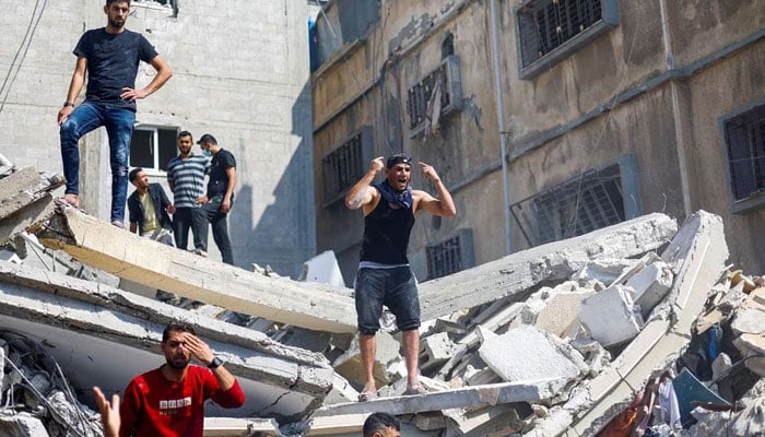 A man reacts as Palestinians gather to search for casualties at the site of an Israeli strike on a house in Khan Younis, in the southern Gaza Strip, October 24, 2023. —Reuters