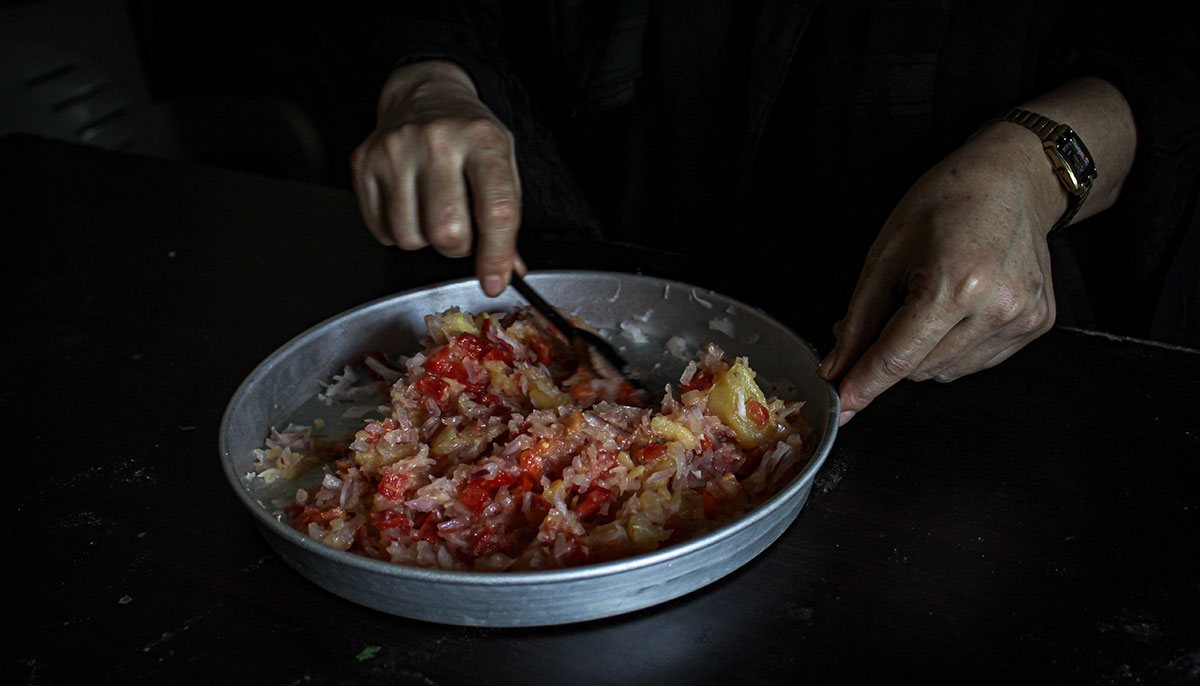 Masooma prepares filling for Afghan snack Bolani. — Hassaan Ahmed