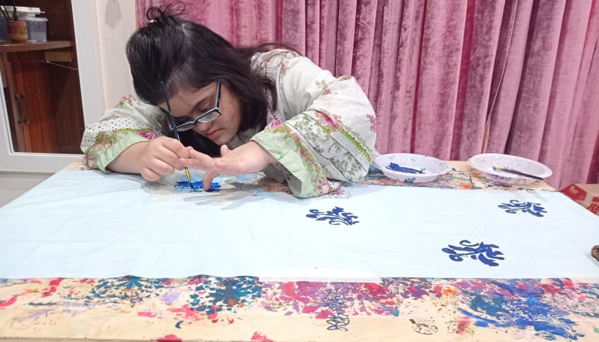 Najla does block printing on a fabric. — Photo by Dr Sajeela Haroon