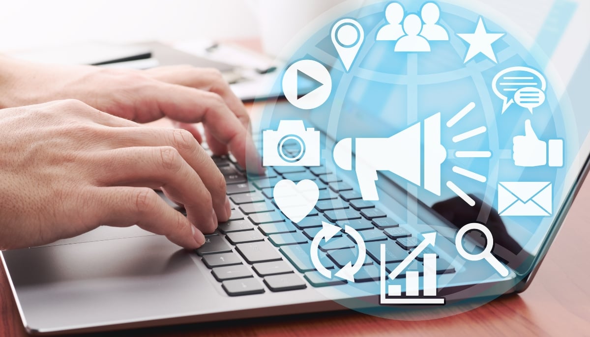 A representational image of a person using a laptop with a social media illustration on top of it. — Canva
