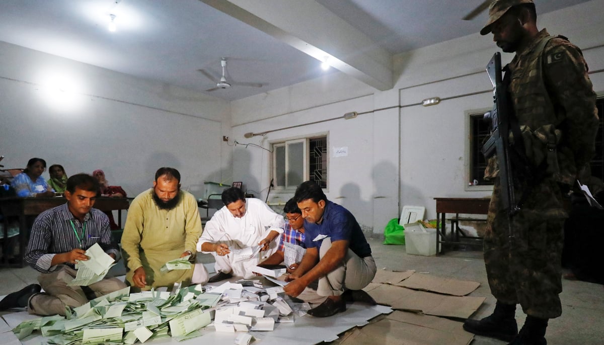 Election officials count votes after polling stations closed during the general election in Karachi, on July 25, 2018. — Reuters