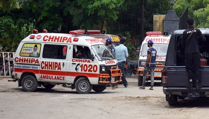 Ambulances are parked outside the Karachi police headquarters on August 2, 2022. —Online
