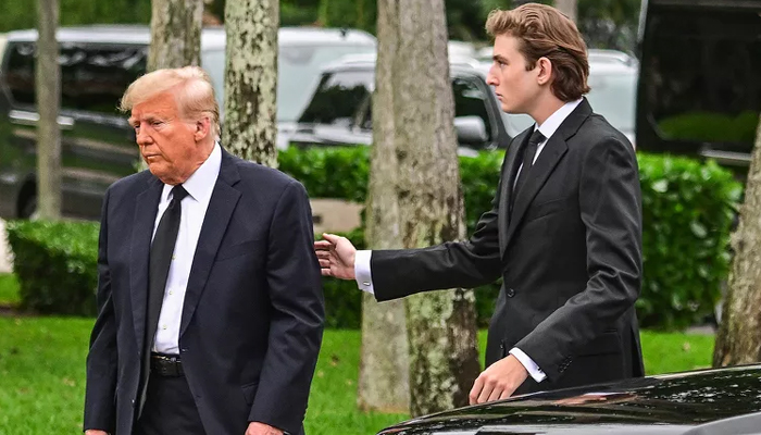 The youngest son of Donald Trump (L) Barron Trump turns 18 and he loves computers. — AFP/File