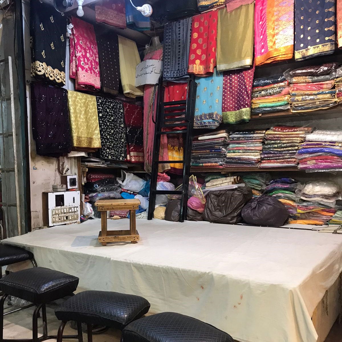 Zakis shop displays a variety of saris in different fabrics, including chaapa design, in Hyderi market, Karachi. &mdash; Photo by author