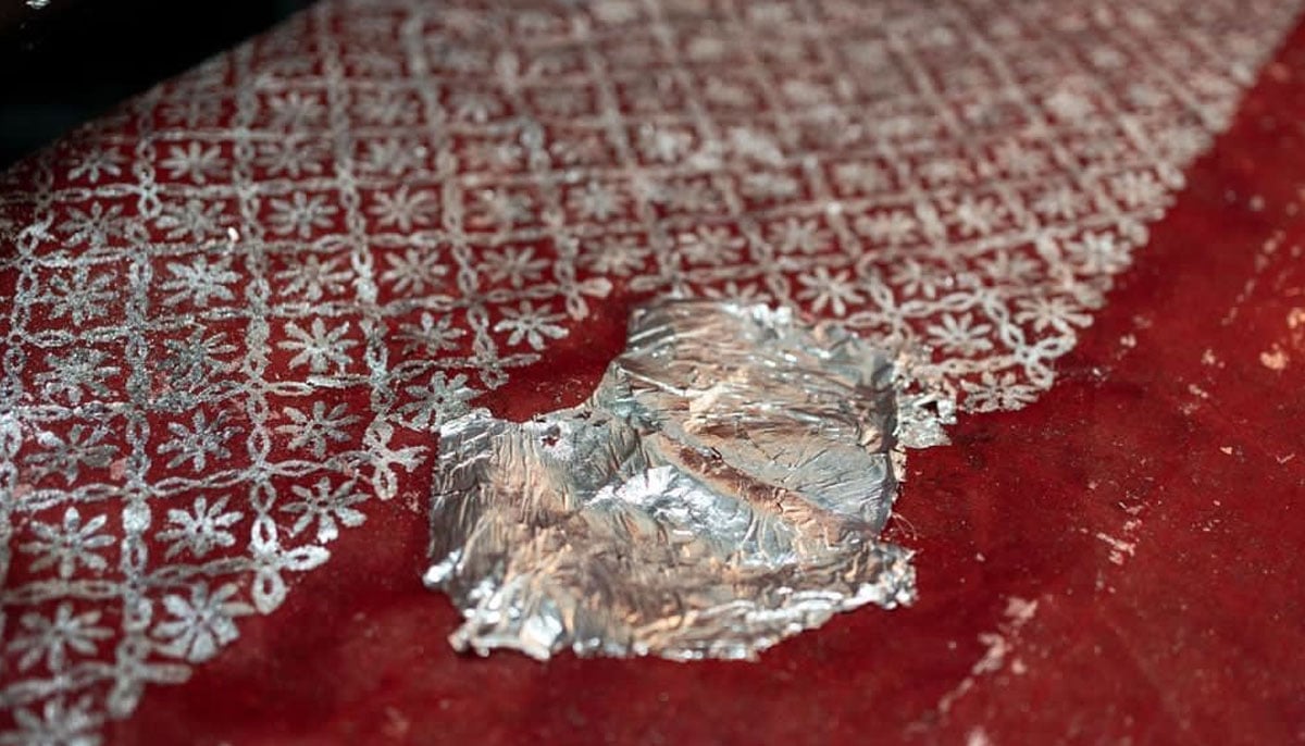 Tabak that forms the silver print is placed on a piece of red fabric. — Photo by Afzal Adeeb Khan
