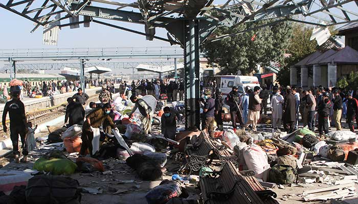 Police officers and people gather at the site amid the debris after a bomb blast at a railway station in Quetta on November 9, 2024. &mdash; Reuters