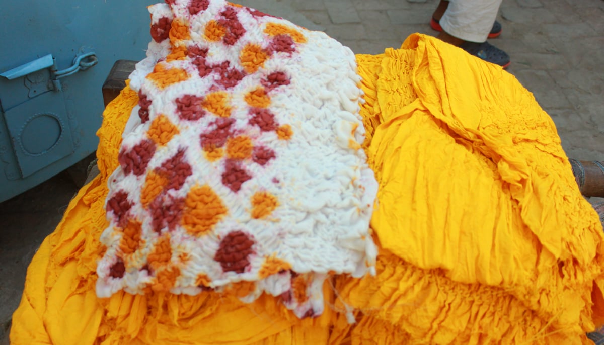 This photograph shows chunari fabric in yellow and white with red dye also in the mix. &mdash; Photo by author