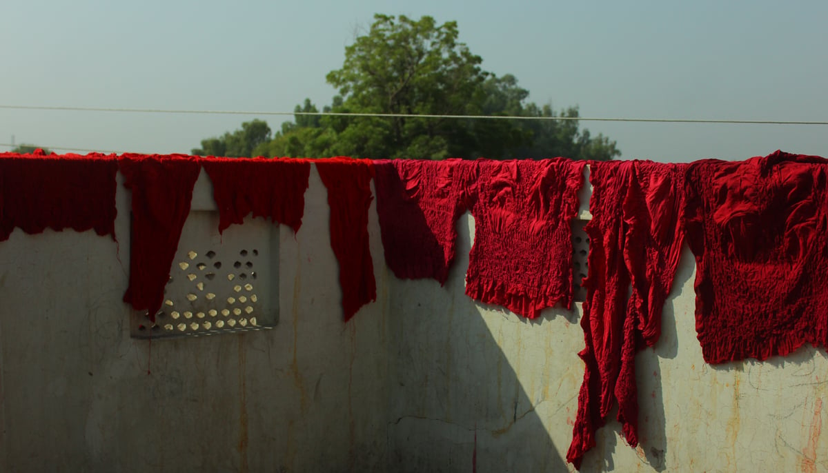 Chunari fabric is hanged on a wall at a home in Abbas Nagar in Bahawalpur. &mdash; Photo by author