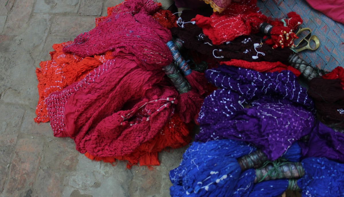 Colourful chunaris are kept on the floor. &mdash; Photo by author