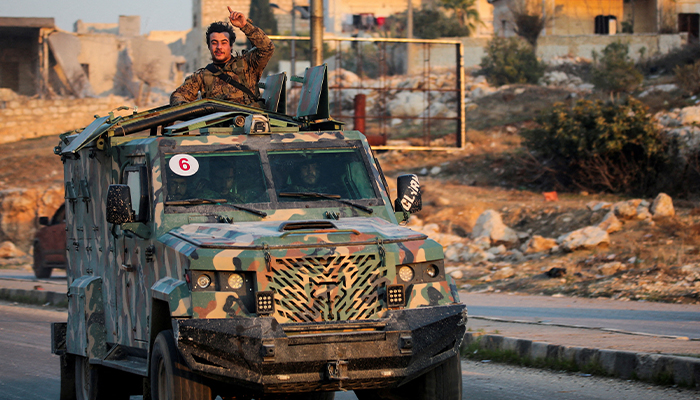 A rebel led by the group Hayat Tahrir al-Sham stands in the back of a vehicle in al-Rashideen, Aleppo province, Syria November 29, 2024. — Reuters