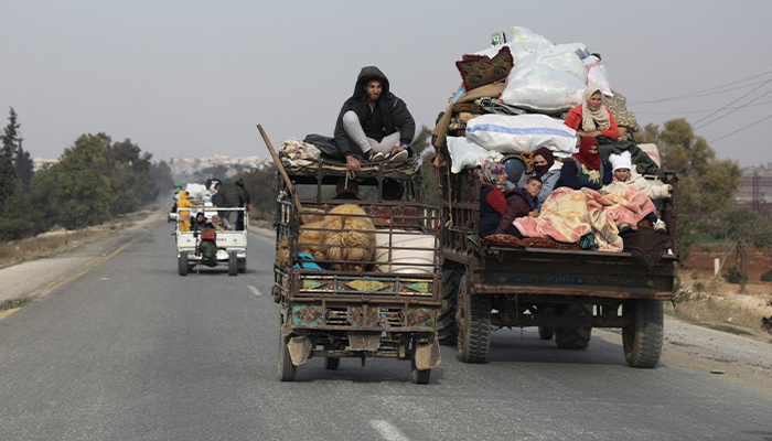 People ride on vehicle with belongings in Hama, after rebels led by HTS have sought to capitalize on their swift takeover of Aleppo in the north and Hama in west-central Syria by pressing onwards to Homs, in Hama, Syria December 6, 2024. — Reuters