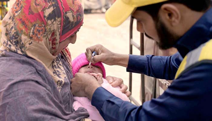 A health worker administers polio drops to child at Nori Gate in Sargodha on Feburary 27, 2024. — APP