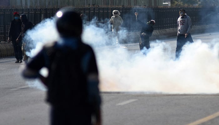 A PTI supporter throws an object towards security force personnel during a protest rally demanding Imran ex-premier Khans release, in Islamabad, November 26, 2024. — Reuters