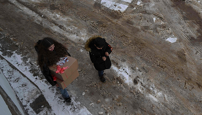 Christian faithful hold Christmas gifts as they leave the Saint Nicholas church after attending a Christmas mass in the small town of Janjevo on December 25, 2024. — AFP