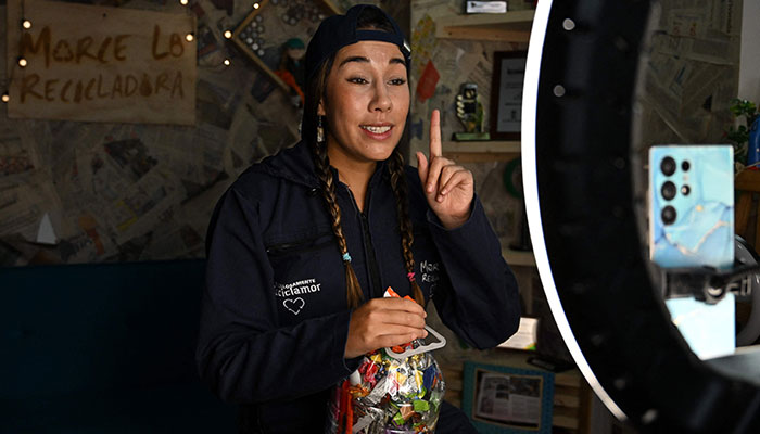 Creator of content for social networks, Sara Samaniego, known as Marce, the recycler, records a video at her house in Bogota on February 26, 2025. — AFP