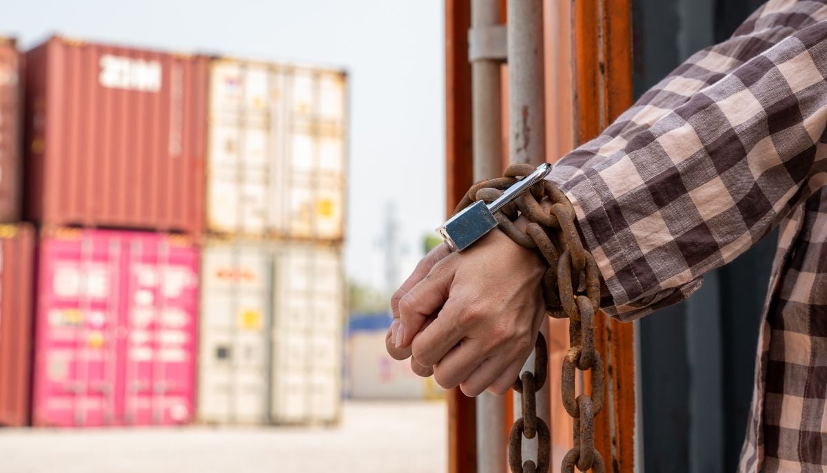 A representational image of a smuggled man handcuffed. — Canva