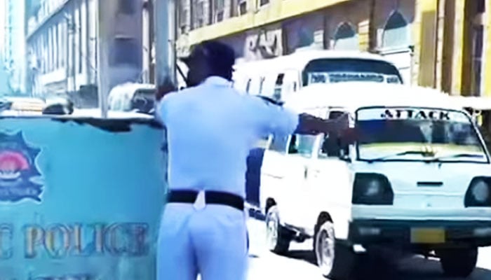 This undated representational image shows a police officer performing his duty amid scorching sun on a road in Karachi. —Facebook/ Karachi Traffic Police/File