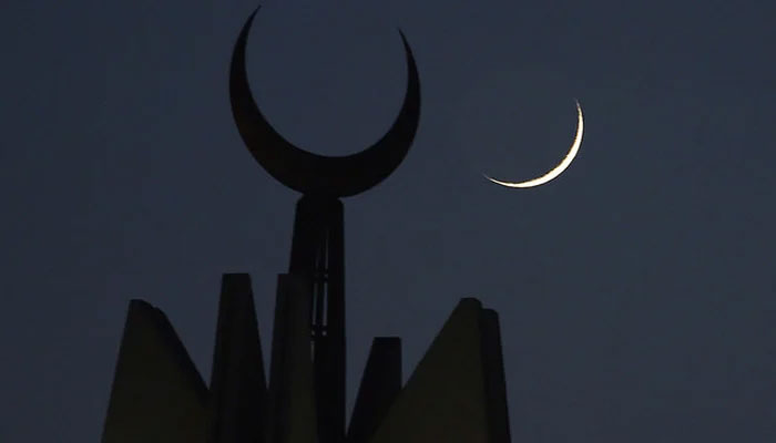 A representational image showing the moon rising over the giant Faisal Mosque in Islamabad. — AFP/File