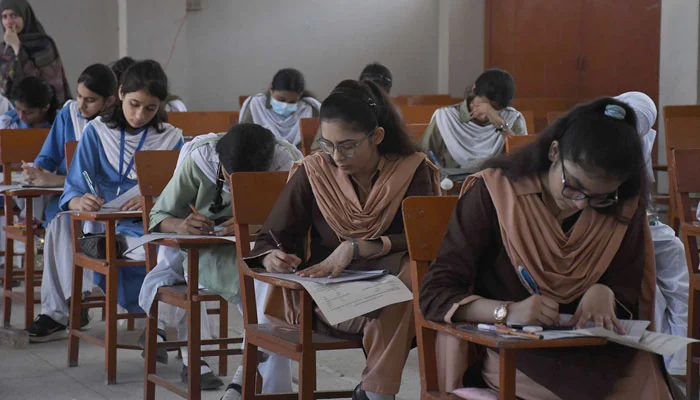 Students of schools solving papers during the annual exam at an examination centre, in Karachi on May 8, 2023. — Online