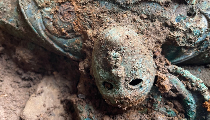 A mask-like decorative human face found as part of the Melsonby hoard of Iron Age artefacts. — Durham University/File