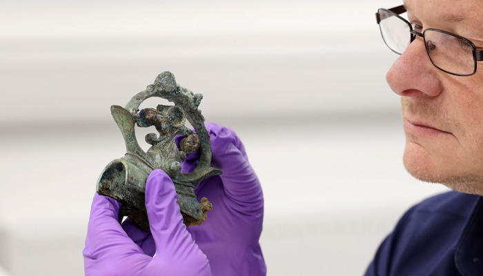 Professor Moore checking an artefact from the hoard. — Durham University/File