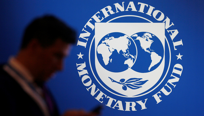 A participant stands near a logo of IMF at the International Monetary Fund - World Bank Annual Meeting 2018 in Nusa Dua, Bali, Indonesia, October 12, 2018. — Reuters
