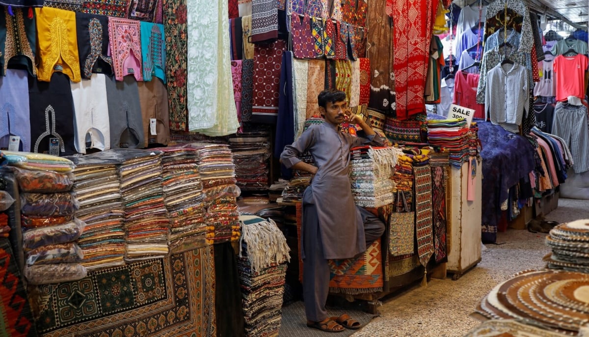 A shopkeeper stands outside his shop while waiting for customers, ahead of Eid ul Fitr celebrations in Karachi on April 19, 2023. — Reuters