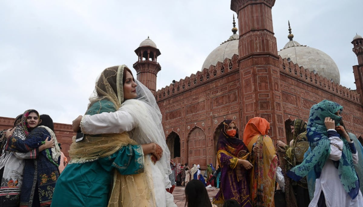 Muslim devotees greet each other after offering Eid prayers at the historical Badshahi Mosque during the Eid al-Adha or the Festival of Sacrifice, in Lahore on July 21, 2021. — AFP