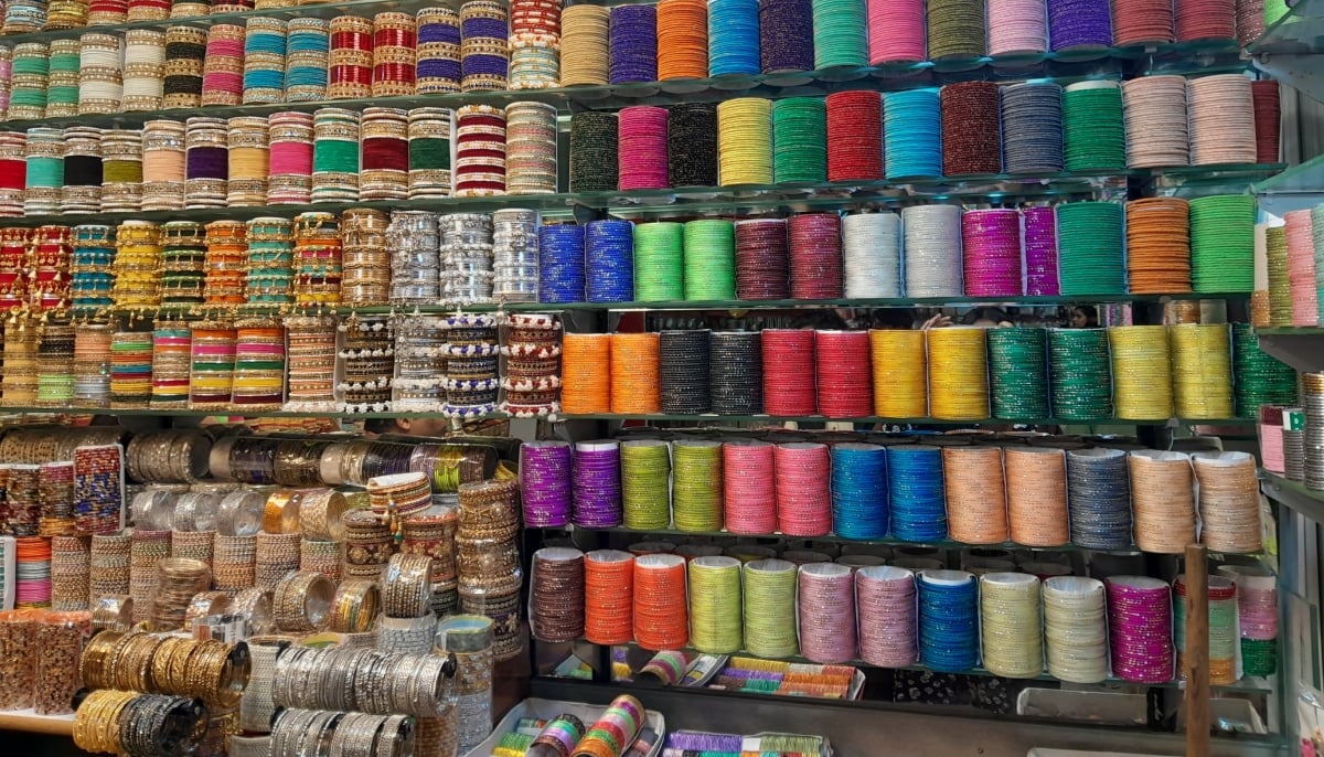 Colourful bangles are displayed at a shop. — Geo.tv