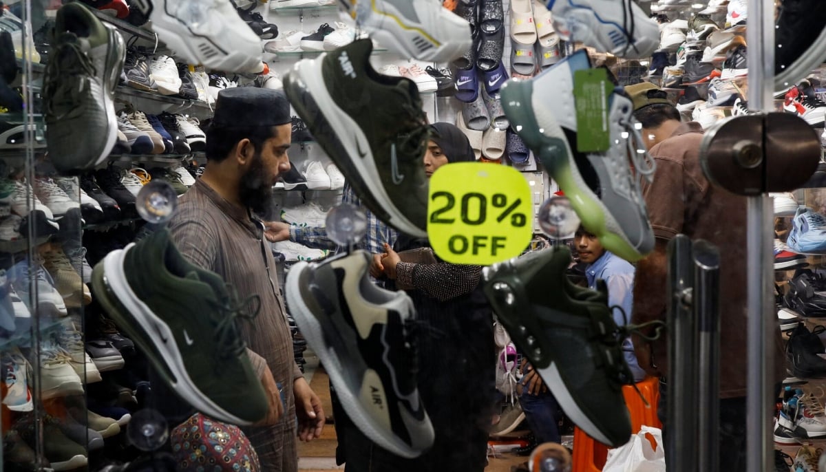People shop for footwear at a market, ahead of Eid ul Fitr celebrations in Karachi on April 19, 2023. — Reuters