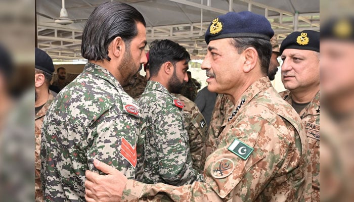 Chief of Army Staff General Asim Munir (right) interacts with troops during his visit to DI Khan and South Waziristan on March 31, 2025. — ISPR