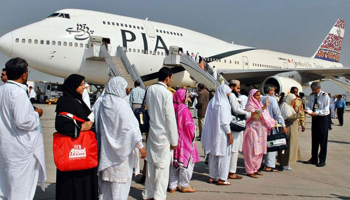 Pilgrims wait in line as they prepare to board a PIA special Hajj pilgrimage flight bound for Saudi Arabia at the Allama Iqbal International Airport in Lahore. — AFP/File