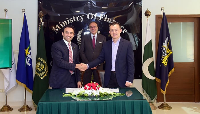 Binance Founder Changpeng Zhao, known as CZ, (centre-right) shaking hands with Pakistan Crypto Council CEO Bilal Bin Saqib (centre-left) after being appointed as strategic adviser. Finance Minister Senator Muhammad Aurangzeb is also present. — Pakistan Crypto Council office