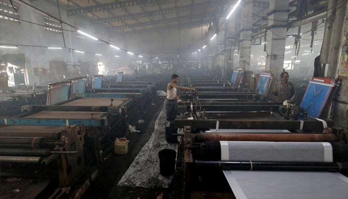 Workers of a textile mill work in this undated image. — Reuters