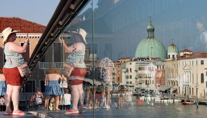 A woman takes a picture from Ponte della Costituzione (Constitution Bridge) in Venice, Italy, September 6, 2020. — Reuters