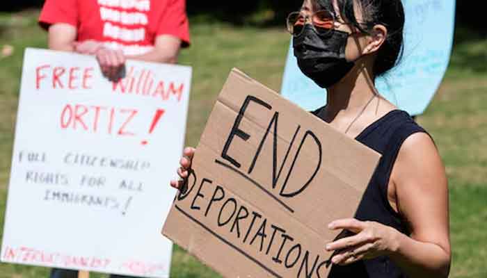 Protesters holding signs take part in a rally to demand the end of deportations in US immigration policy, at Silver Lake Reservoir in Los Angeles, California, US. — Reuters/File