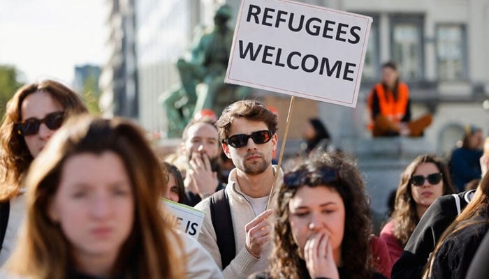 Human rights activists protest outside the European Parliament ahead of a vote by lawmakers on the EUs Pact on Asylum and Migration, in Brussels, Belgium, April 10, 2024. —
