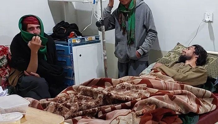 A patient, along with his attendants, is pictured at a hospital in Kurram district on November 24, 2024. — AFP/File