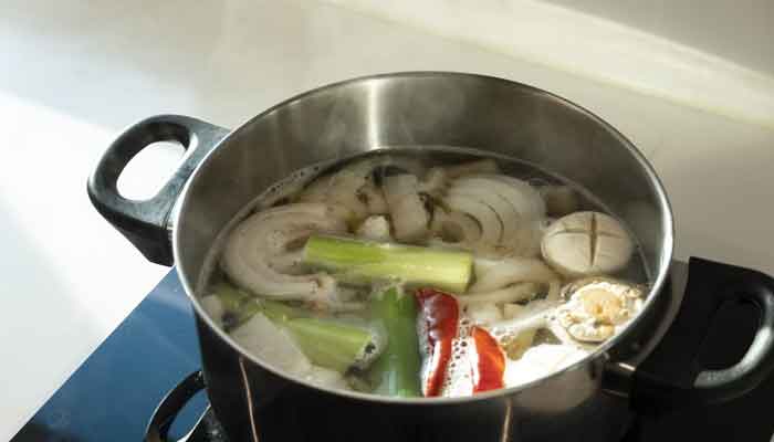 A representational image shows a pot containing broth with vegetables. — Unsplash/File