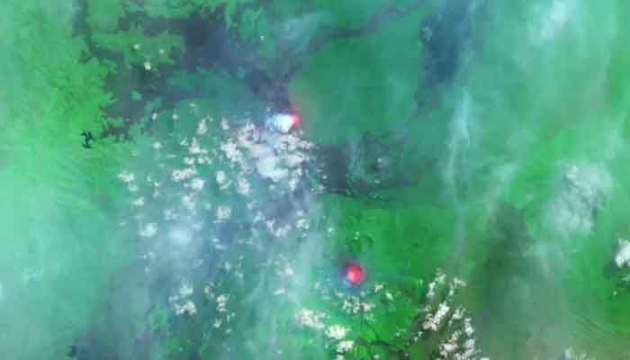 The lava lakes of Nyamuragira (top) and Nyiragongo (bottom) glow red in this 2014 satellite image captured using infrared radiation. — Nasa/File