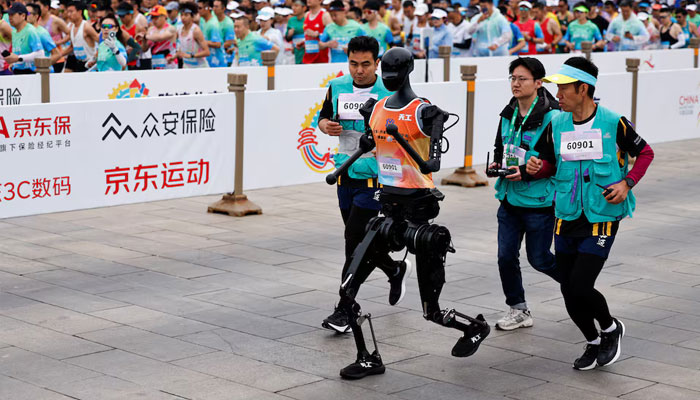Humanoid robot Tiangong participates along with human runners in the E-Town Half Marathon & Humanoid Robot Half Marathon in Beijing, China April, 19 2025. — Reuters