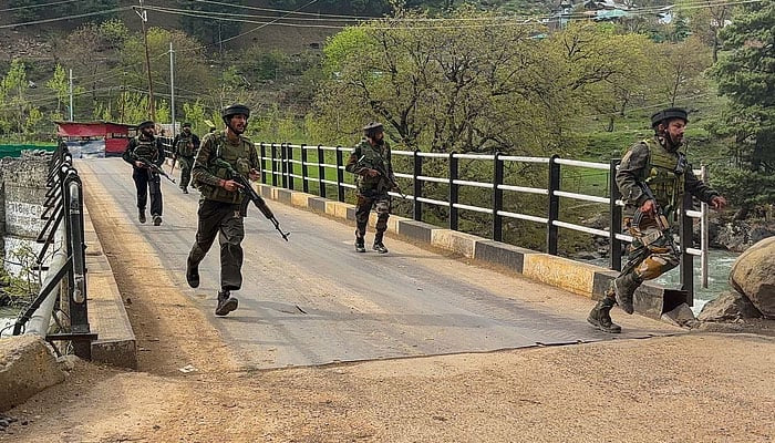 Security personnel rush to the scene of the attack in IIOJKs Pahalgam area. — Press Trust of India