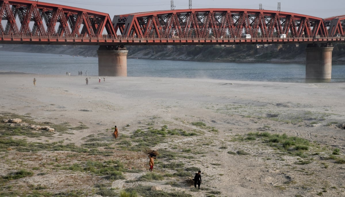People walk on the dry riverbed of the Indus River in Hyderabad, Pakistan April 24, 2025. — Reuters