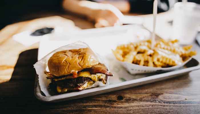 A representational image shows a slider plate containing a burger and fries. — Unsplash/File